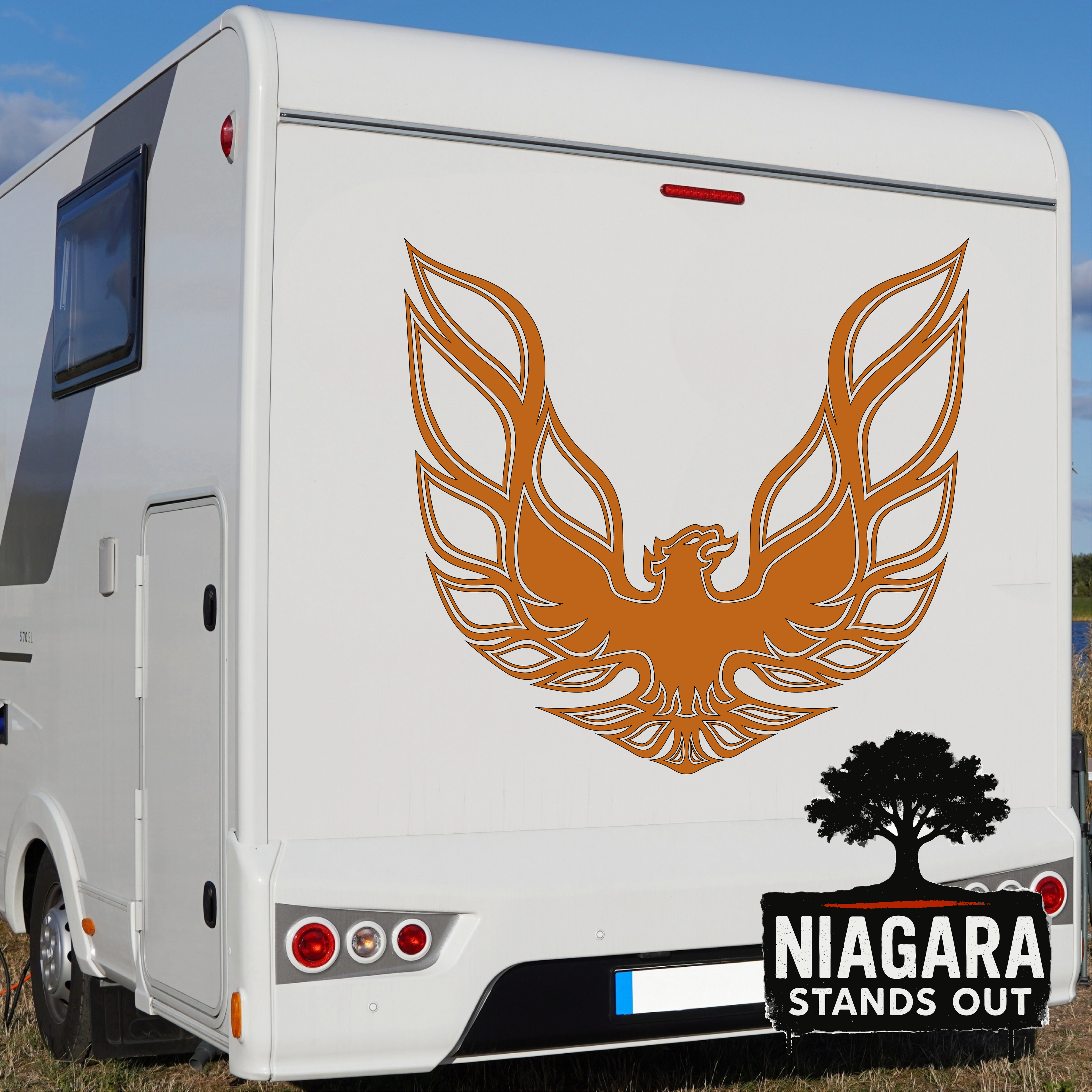 Orange eagle vinyl decal in flight above black tree silhouette with 'Niagara Stands Out' text for RV or car exterior