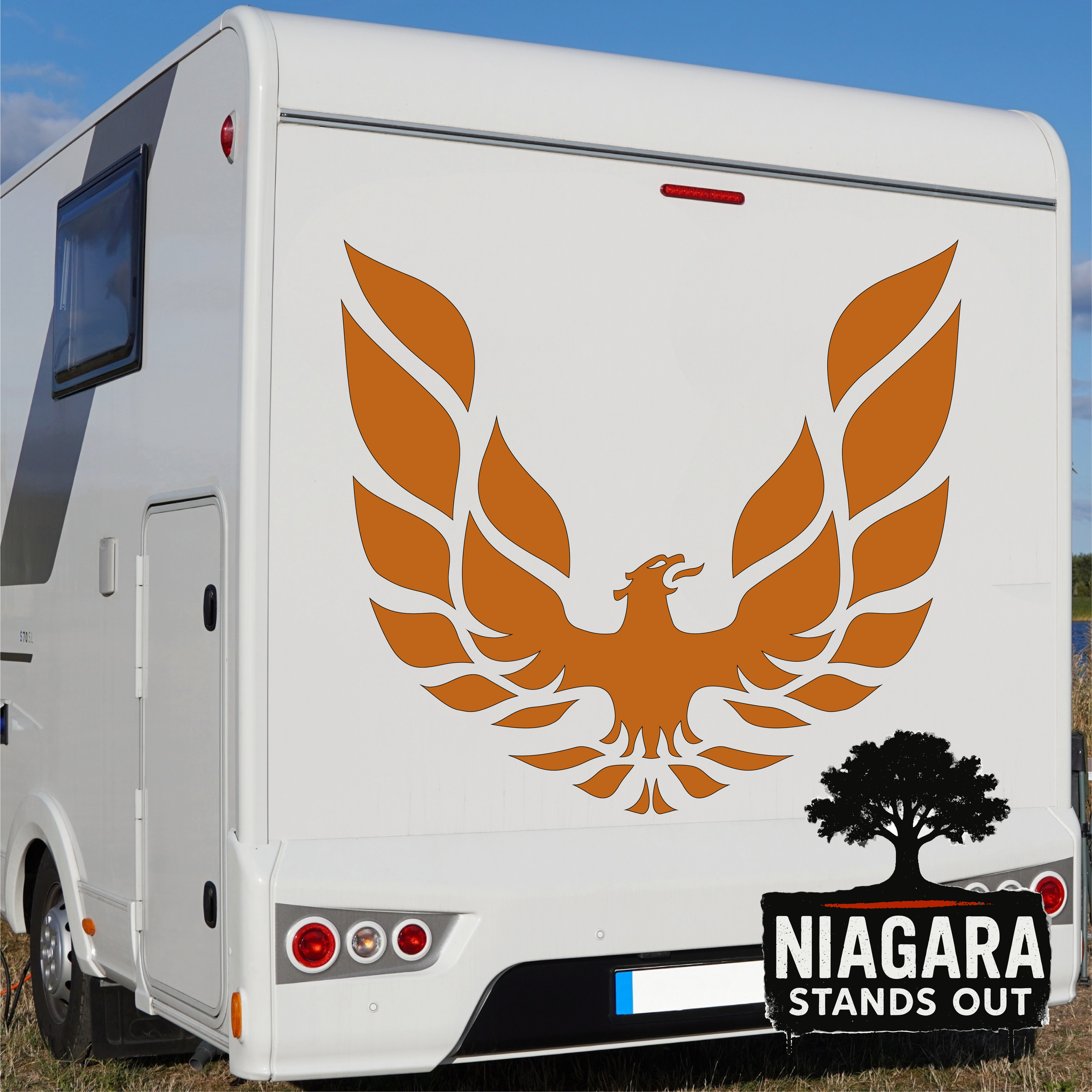 Orange eagle vinyl decal in flight above black tree silhouette with 'Niagara Stands Out' text for RV or car exterior
