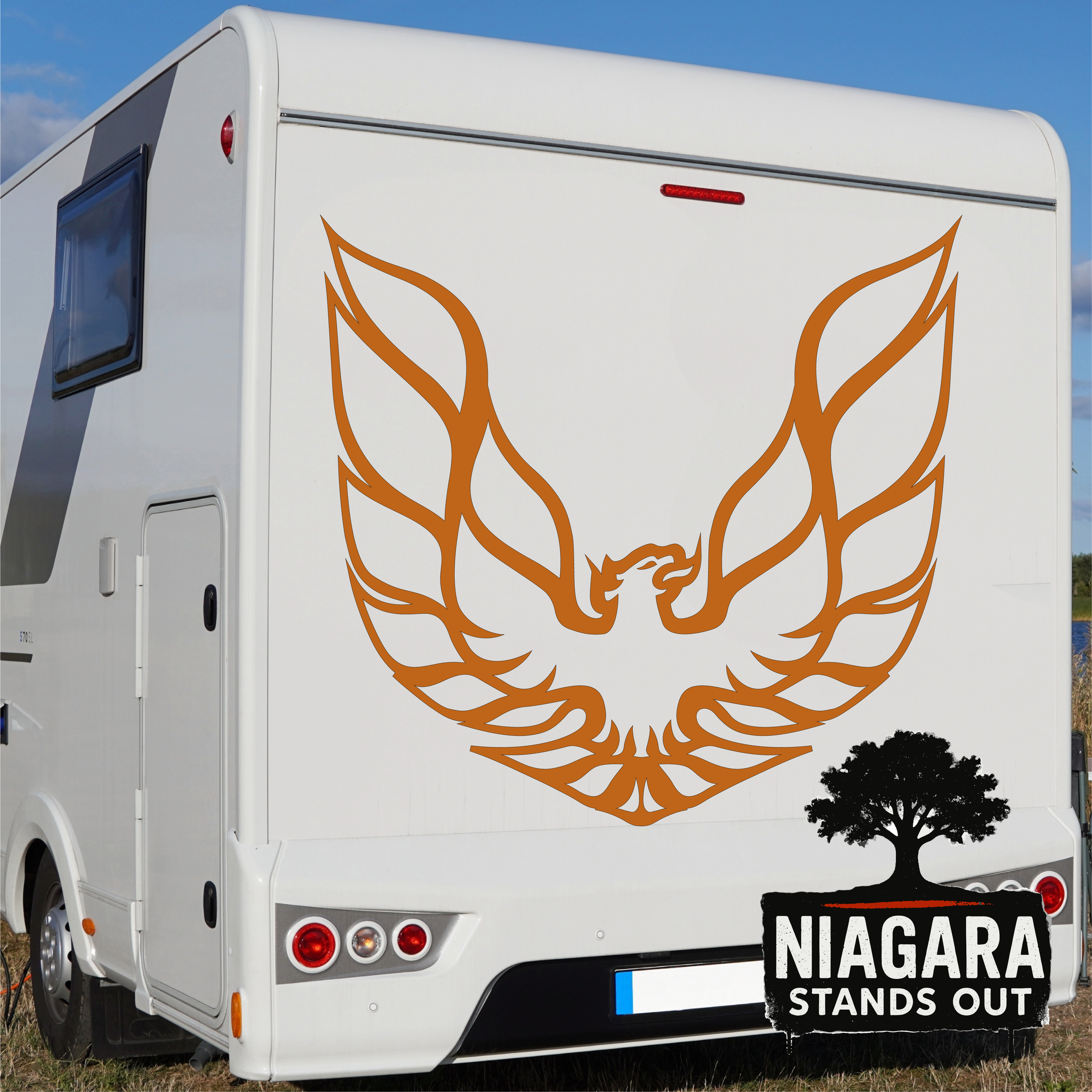 Orange eagle vinyl decal in flight above black tree silhouette with 'Niagara Stands Out' text for RV or car exterior