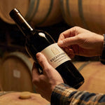 A close-up view of custom roll labels featuring a glossy white finish, showcasing vibrant colors and clear text, designed for high-end retail packaging. The labels are wound on a standard 3-inch core, emphasizing their industrial-grade quality and suitabi